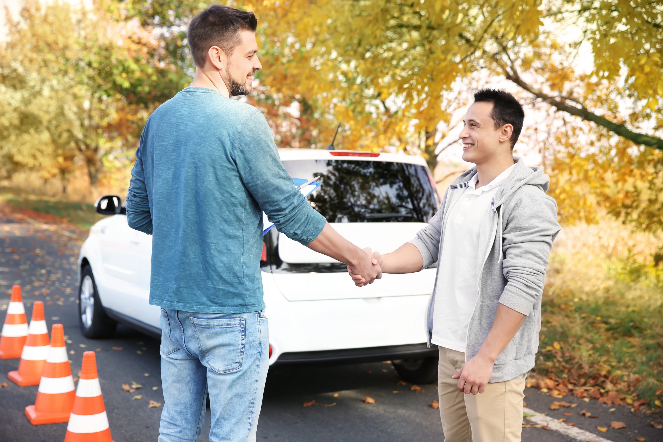 Instructor and Young Man Passed a Driving License Exam